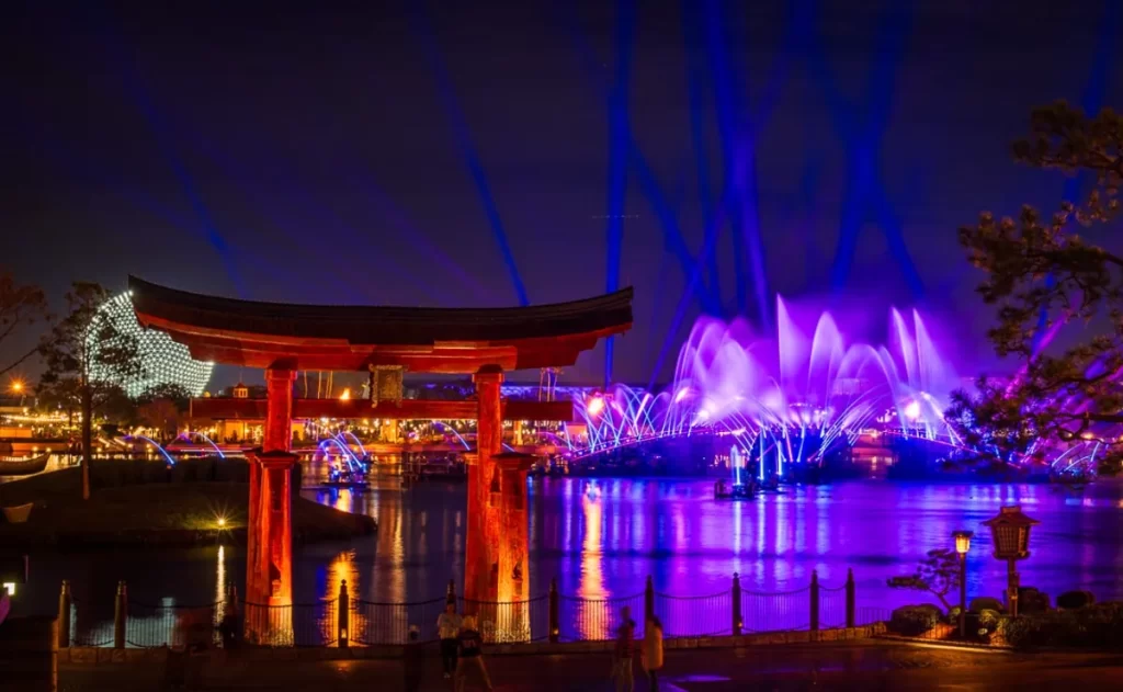 Vista noturna do torii japonês com fontes e luzes do Luminous ao fundo