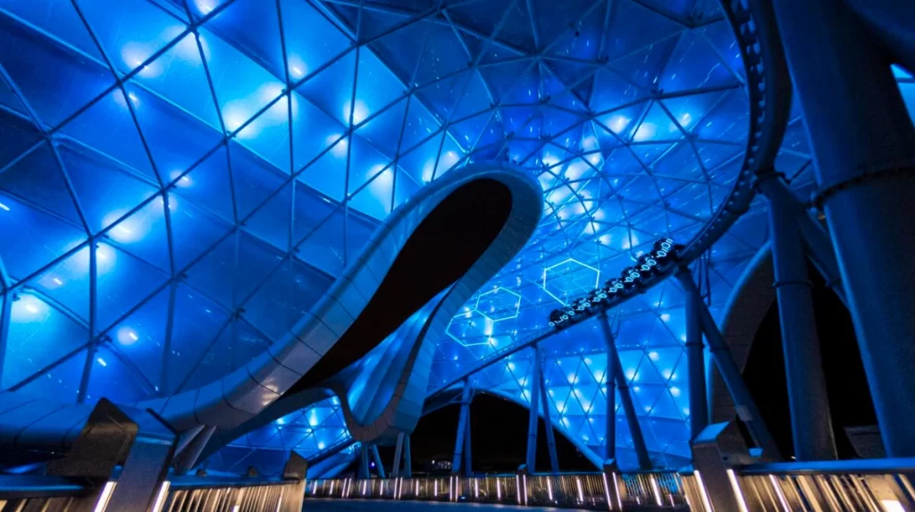 Montanha-russa TRON Lightcycle Run no Magic Kingdom iluminada em azul neon à noite