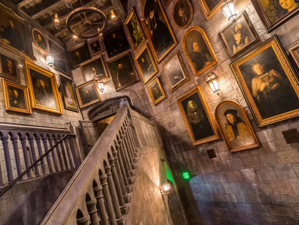 Corredor dos Retratos dentro do Castelo de Hogwarts na atração “Forbidden Journey” — pinturas mágicas em movimento decoram as paredes.