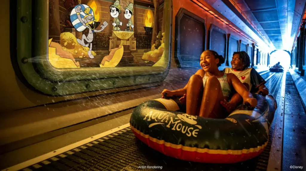 Crianças descendo na atração Aquamouse do Disney Wish em boia dentro de tubo aquático.